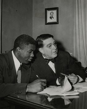 Work:&nbsp;Jackie Robinson signs his contract