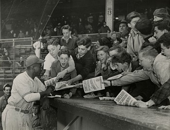 Work:&nbsp;Jackie Robinson stands surrounded by eager autograph seekers